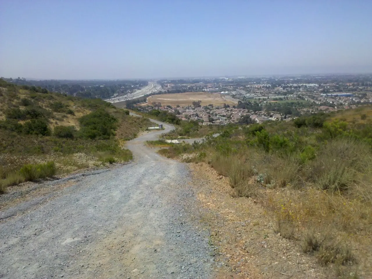In the picture I can see a way and there is greenery ground on either sides of it and there are few...