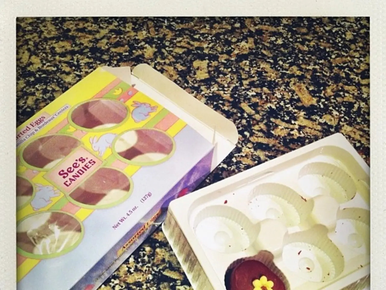 In this image there is a box. Beside there is a tray having some food in it. They are kept on the...