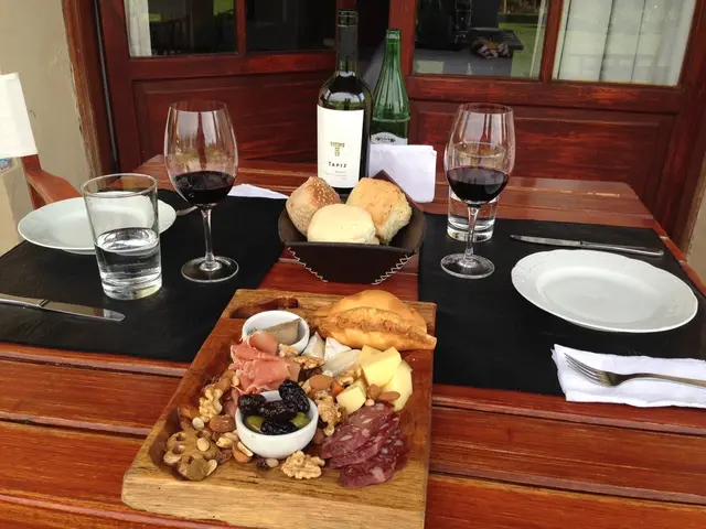 Here we can see a dining table and food items on it,and her is the glass and spoons and wine bottle...